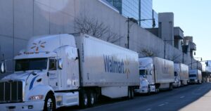 Two Walmart branded heavy duty trucks parked in a row