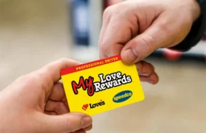 Yellow Love's Reward card being handed to another person.